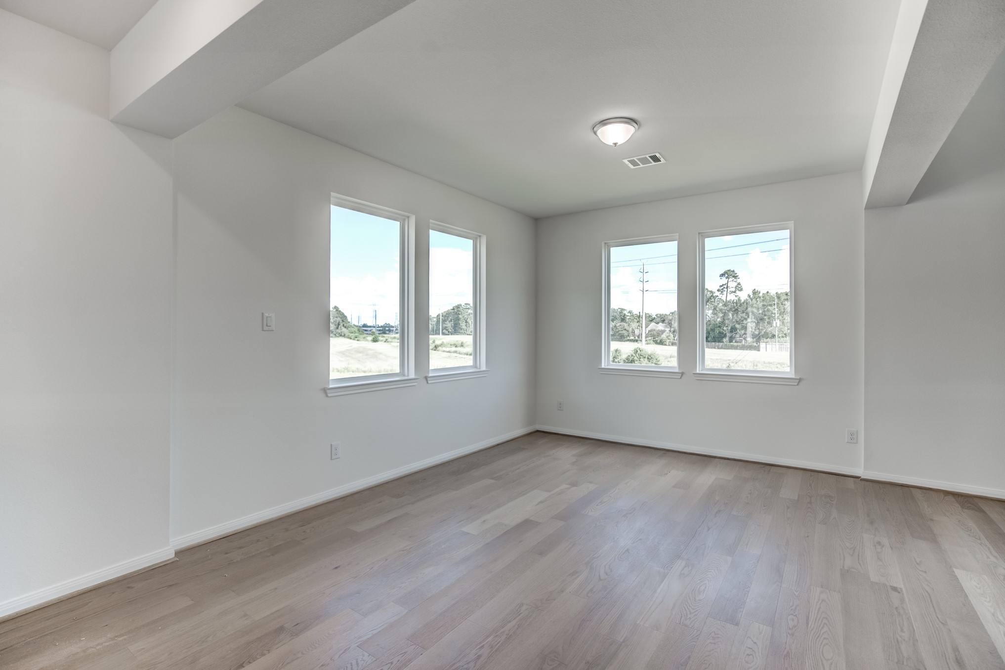 20630 Dynamic Court Humble, TX 77338 - Photo 13 of 28 a view of an empty room with wooden floor and a window