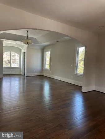 a view of a room with wooden floor and window