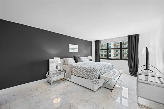 a bedroom with a bed wooden floor and window