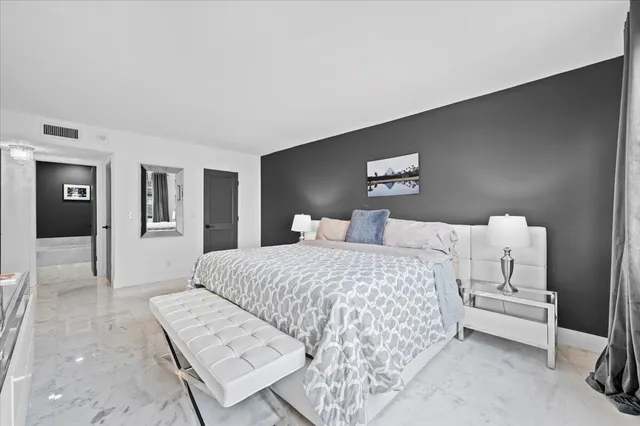 a bedroom with a bed and a lamp