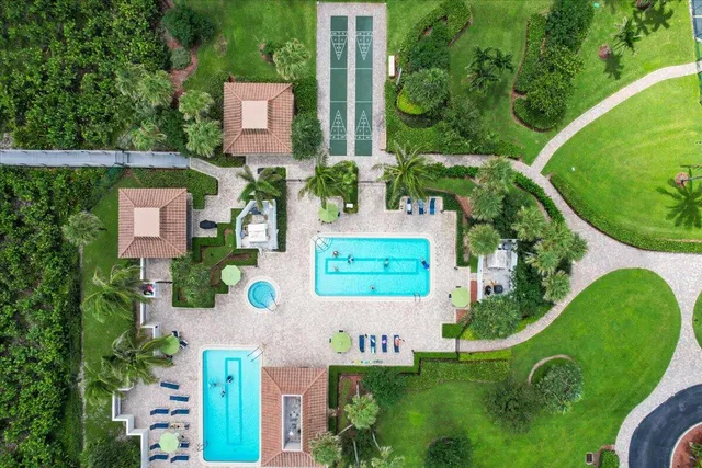 an aerial view of ocean and residential houses with outdoor space