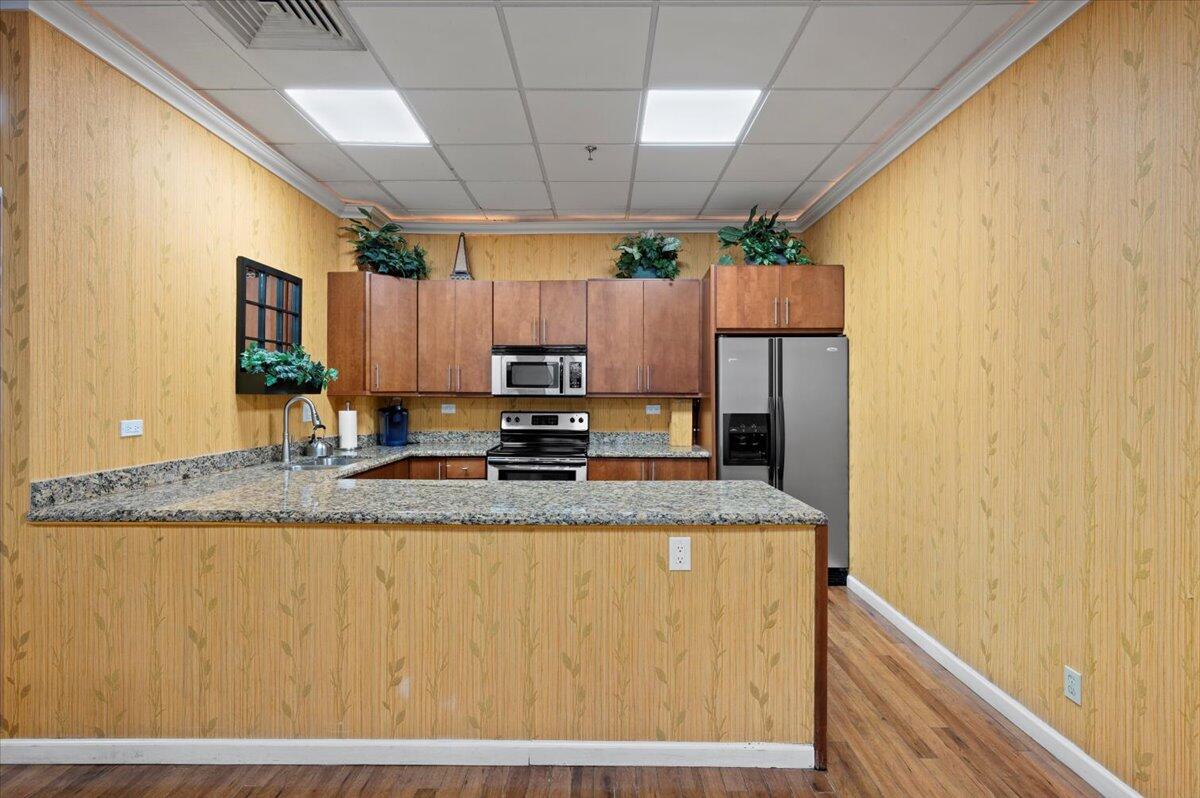 3400 North Ocean Drive, Unit 1806 Singer Island, FL 33404 - Photo 42 of 55 a kitchen with a sink a counter top space cabinets and stainless steel appliances