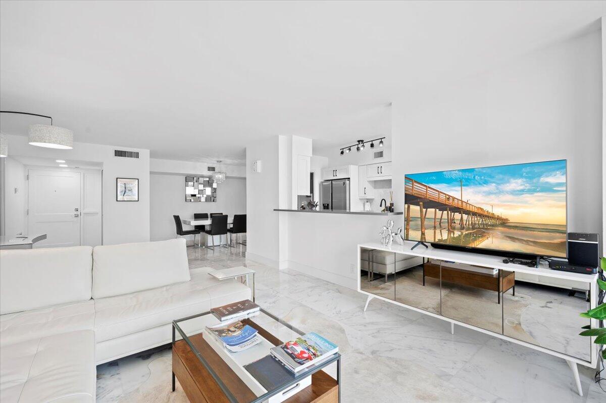 3400 North Ocean Drive, Unit 1806 Singer Island, FL 33404 - Photo 5 of 55 a living room with furniture and a flat screen tv