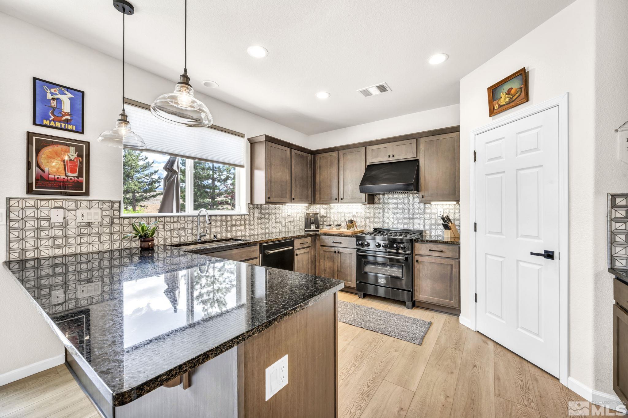 1433 Washington Street Reno, NV 89503 - Photo 17 of 35 a large kitchen with stainless steel appliances granite countertop a stove and a sink