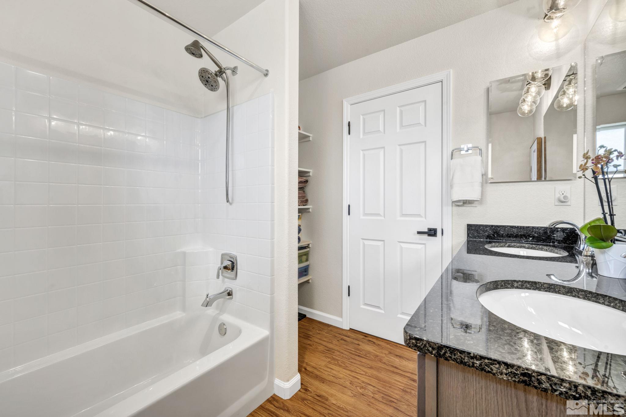 1433 Washington Street Reno, NV 89503 - Photo 30 of 35 a bathroom with a granite countertop tub sink and mirror