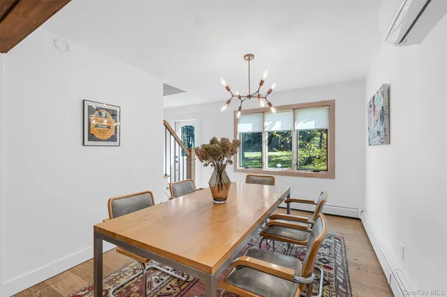 a kitchen with a refrigerator a stove top oven a sink dishwasher and white cabinets with wooden floor