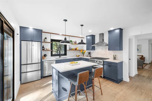 a large kitchen with a table and chairs