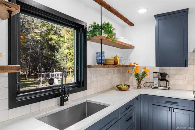 a kitchen with a sink stove top oven and cabinets