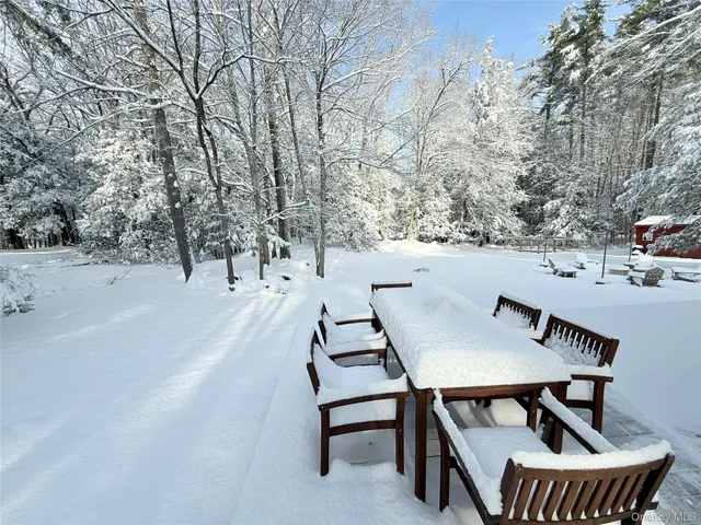 a view of a patio with table and chairs with wooden floor and fence