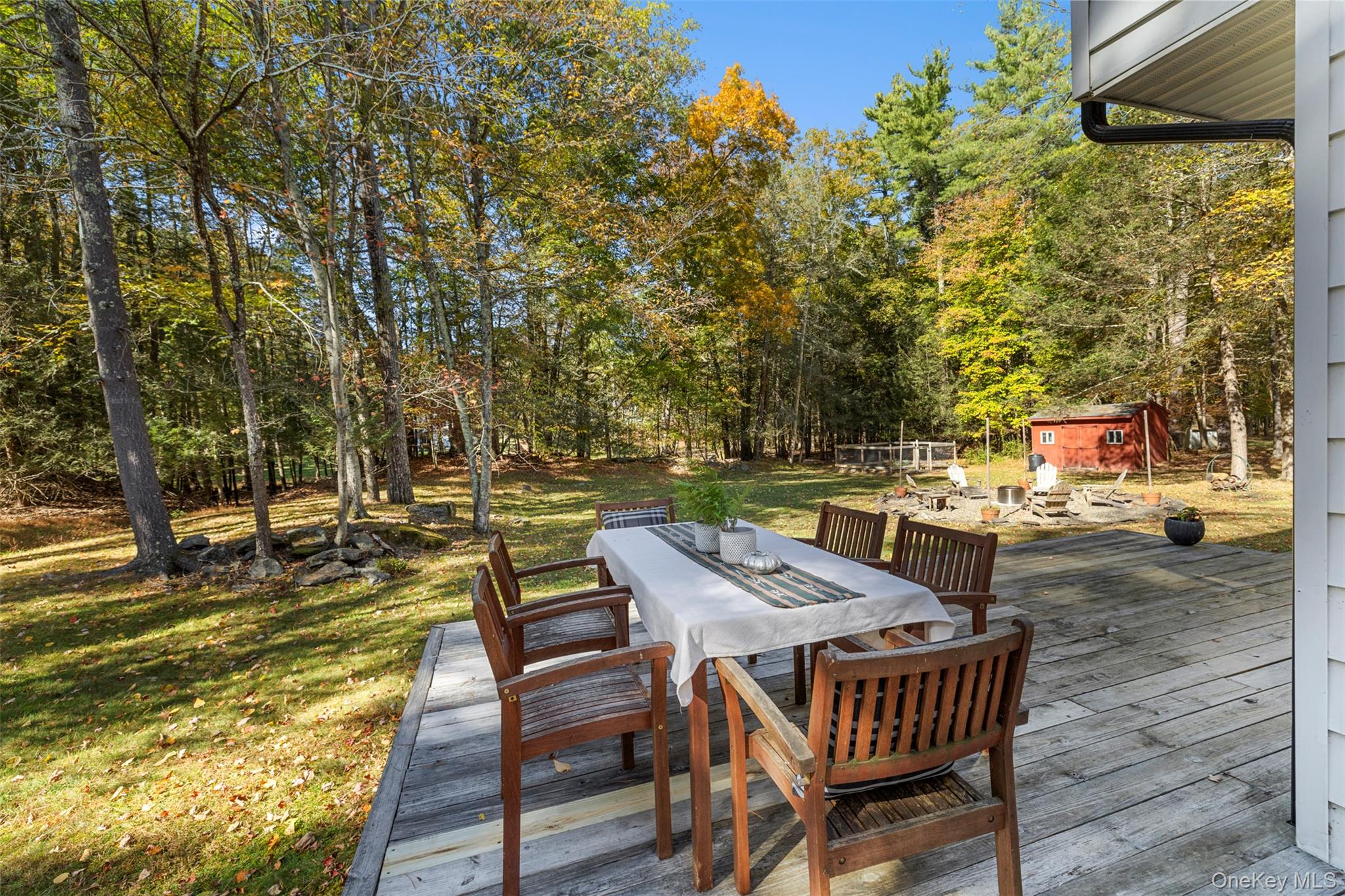 90 Van Dale Road Woodstock, NY 12498 - Photo 24 of 49 a view of a patio with table and chairs with wooden floor and fence