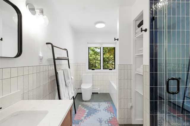 a bathroom with a sink toilet and shower