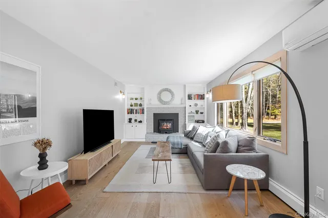 a living room with furniture fireplace and flat screen tv