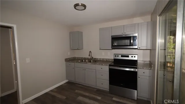 a kitchen with a sink and a stove top oven
