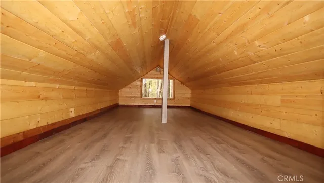 a view of a room with wooden floor and white walls