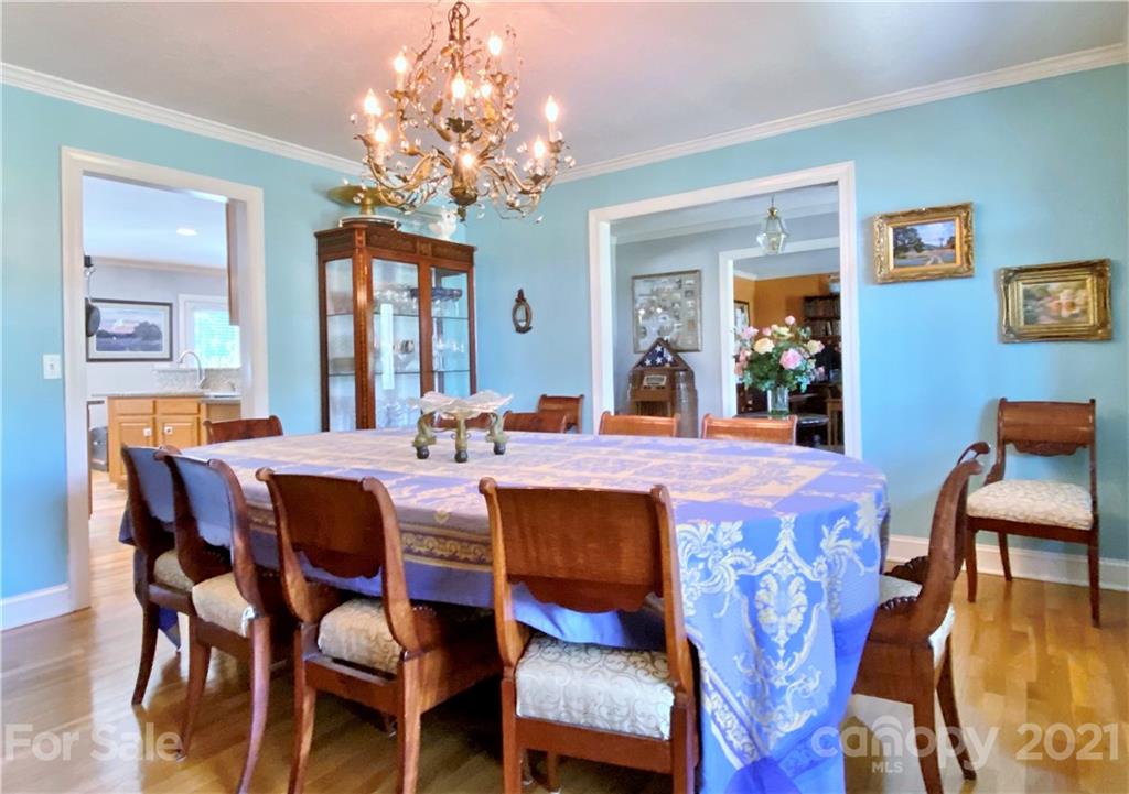 2280 Gheen Road Salisbury, NC 28147 - Photo 12 of 39 a dining room with wooden floor a chandelier a wooden table and chairs