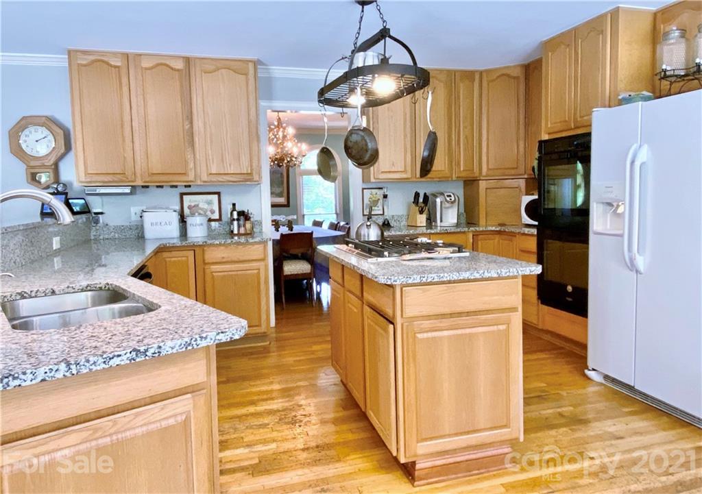 2280 Gheen Road Salisbury, NC 28147 - Photo 16 of 39 a kitchen with stainless steel appliances granite countertop a sink a stove counter space and cabinets