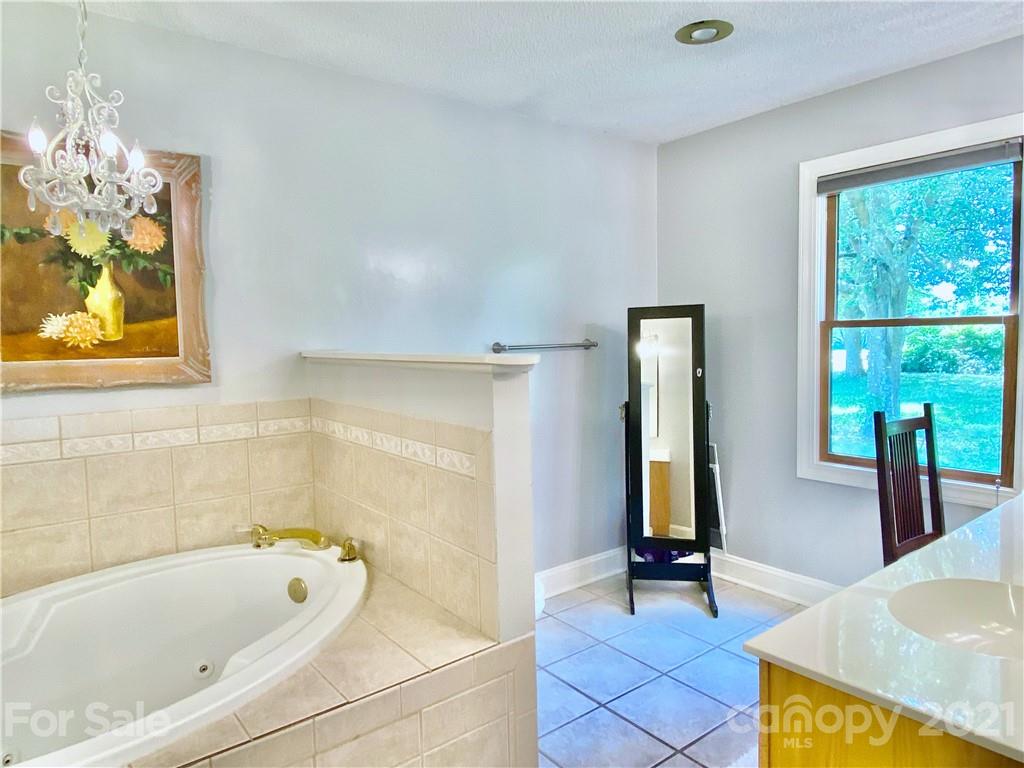 2280 Gheen Road Salisbury, NC 28147 - Photo 23 of 39 a bathroom with a tub a sink and a window