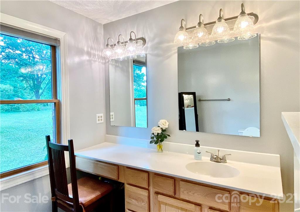 2280 Gheen Road Salisbury, NC 28147 - Photo 25 of 39 a bathroom with a sink vanity and a mirror