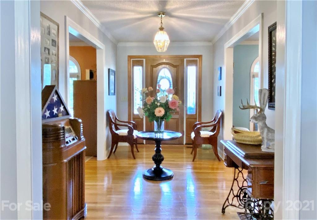 2280 Gheen Road Salisbury, NC 28147 - Photo 10 of 39 a living room with furniture a dining table and a chandelier