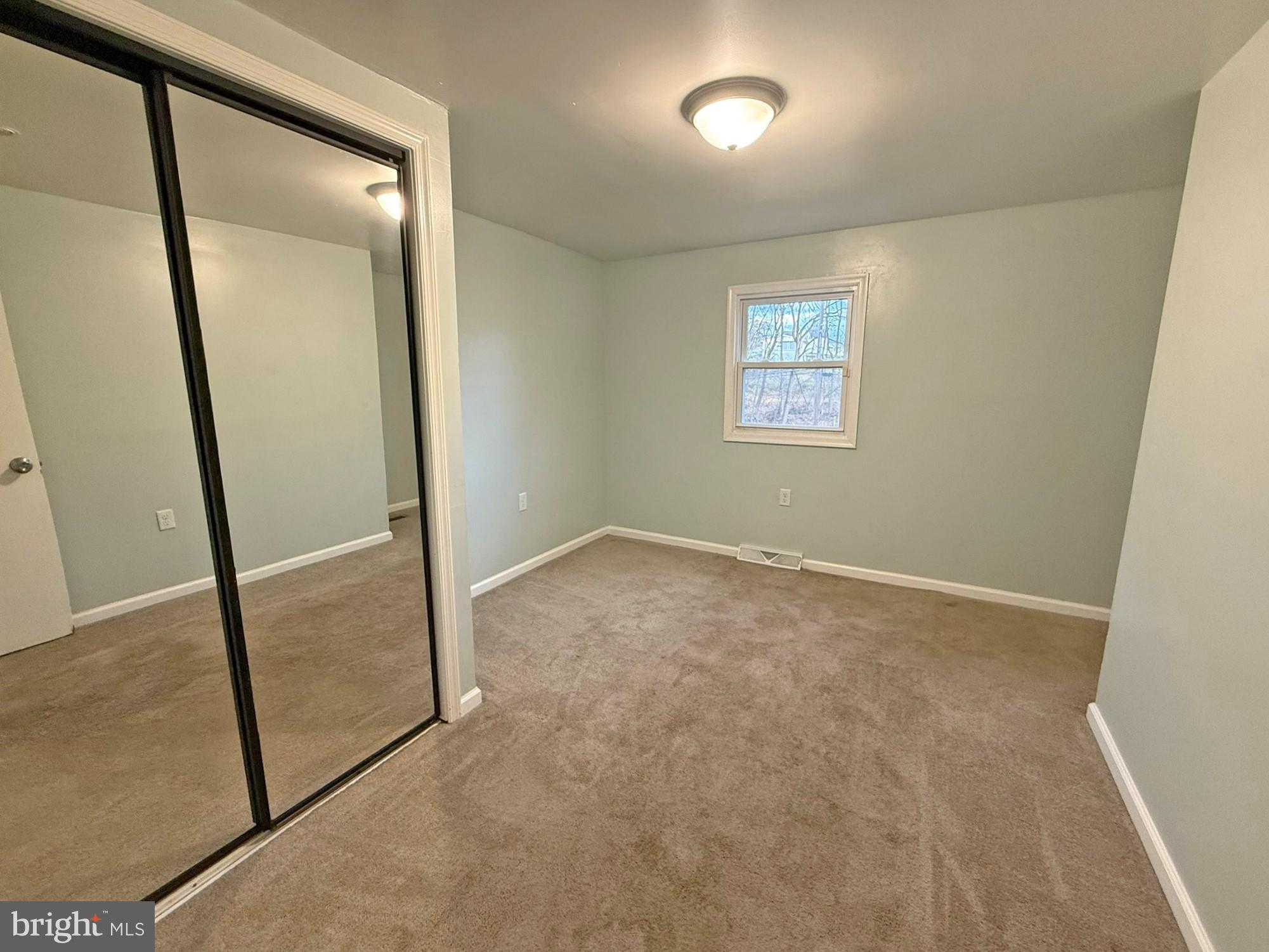 1316 Edgemont Road Harrisburg, PA 17109 - Photo 11 of 21 an empty room with mirror on the wall