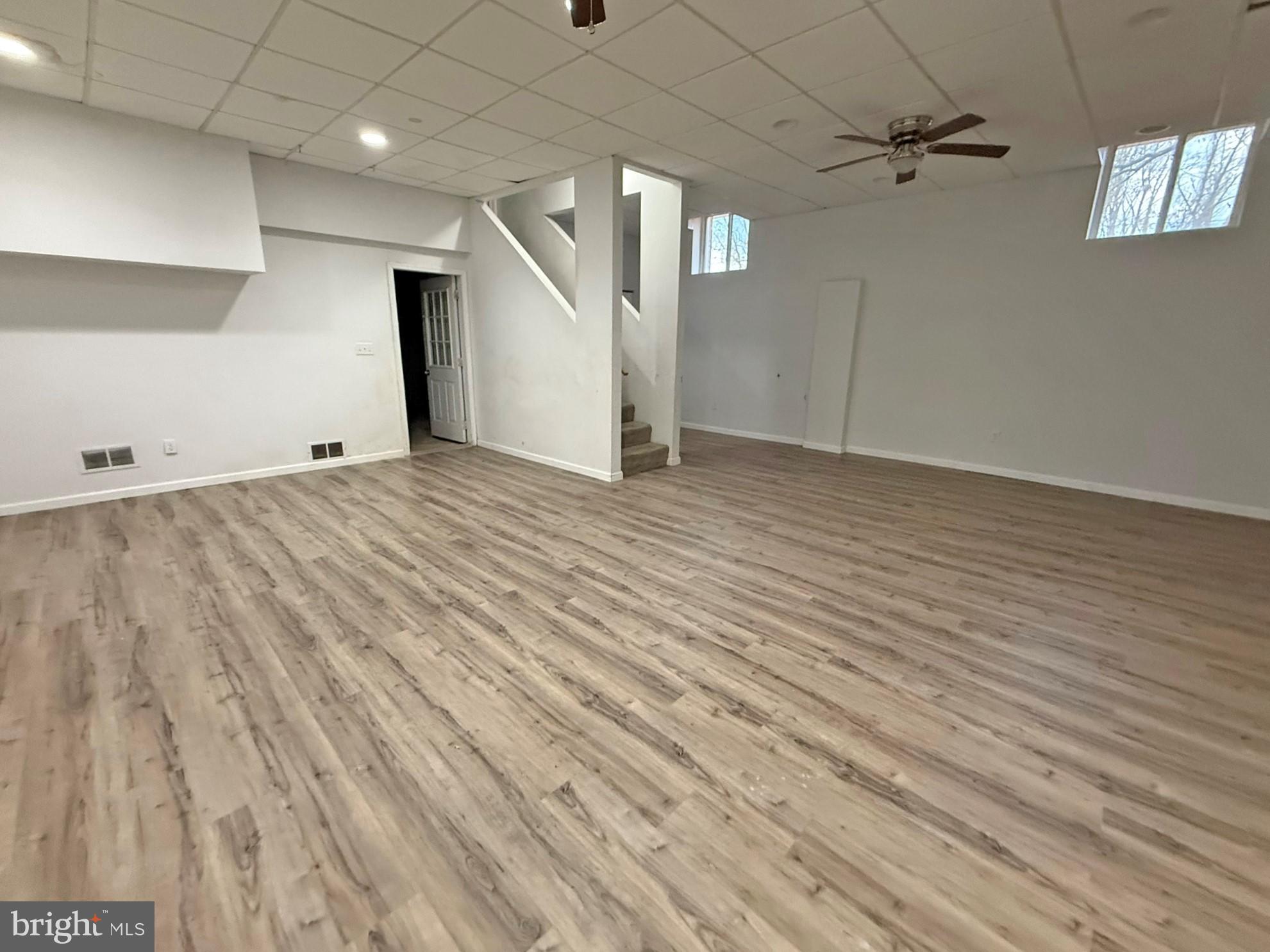 1316 Edgemont Road Harrisburg, PA 17109 - Photo 13 of 21 an empty room with wooden floor ceiling fan and windows