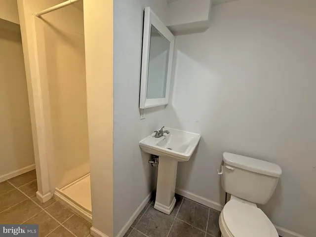 a bathroom with a sink toilet and a mirror