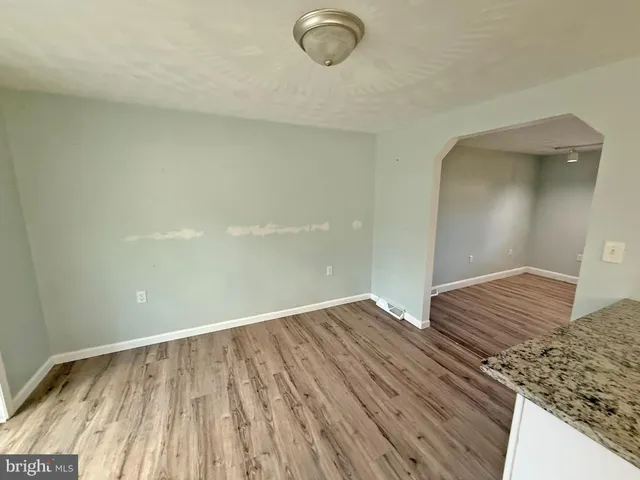 a view of room with wooden floor