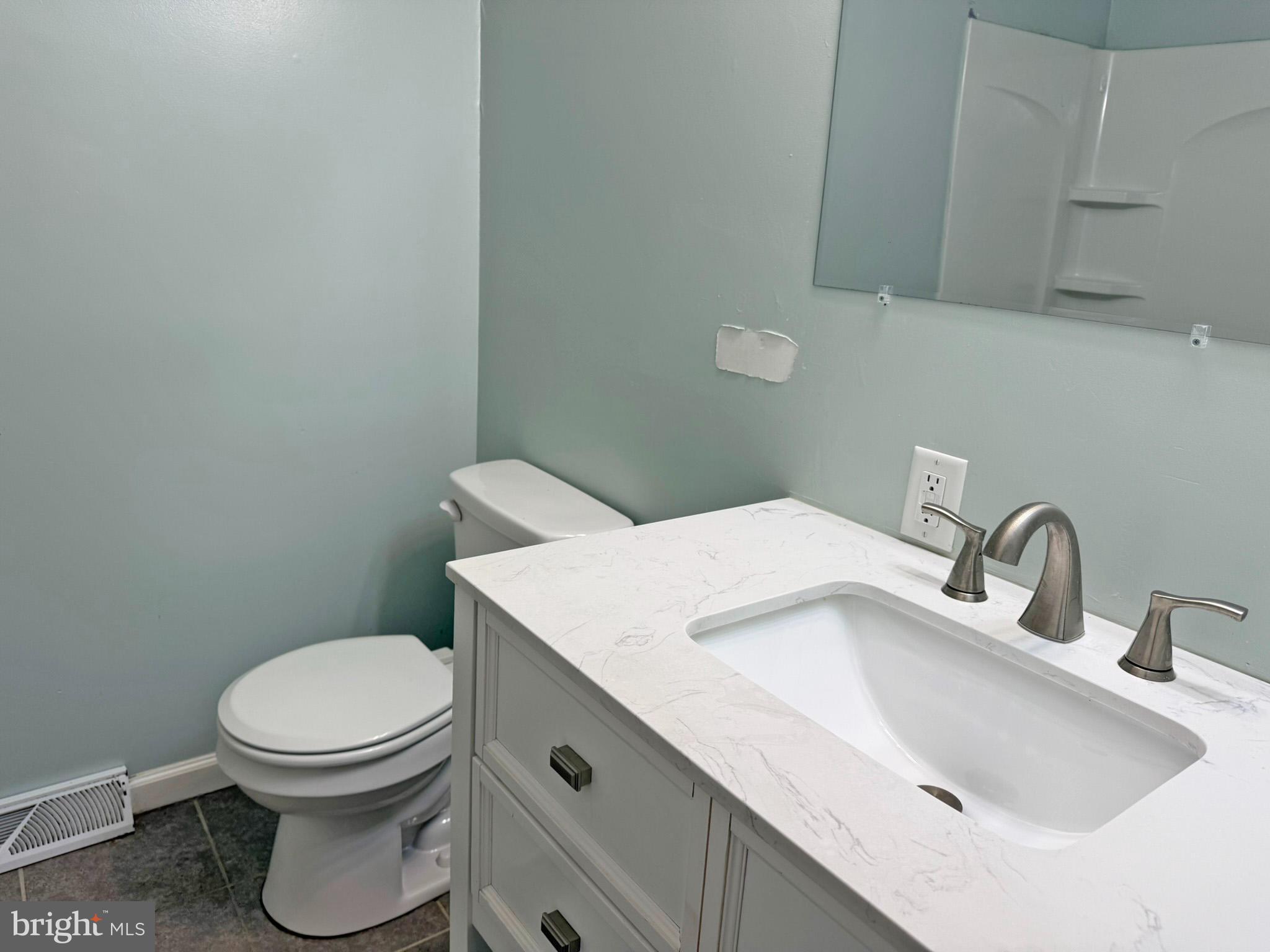 1316 Edgemont Road Harrisburg, PA 17109 - Photo 6 of 21 a bathroom with a sink a toilet and mirror