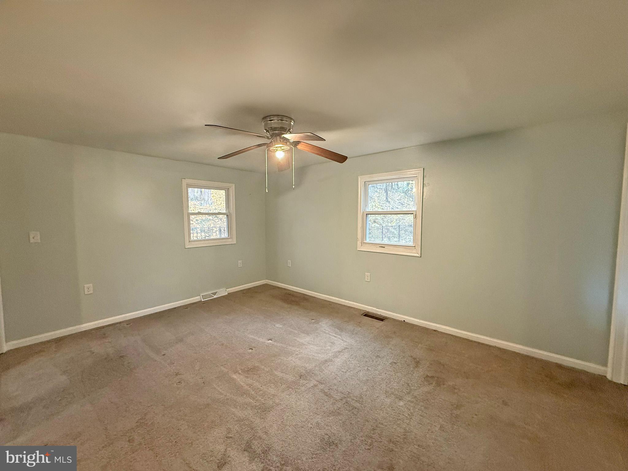 1316 Edgemont Road Harrisburg, PA 17109 - Photo 8 of 21 an empty room with windows and fan