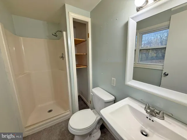 a white toilet sitting next to a bathroom sink