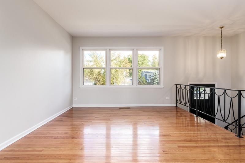 7924 Westview Lane Woodridge, IL 60517 - Photo 11 of 40 a view of an empty room with wooden floor and a window