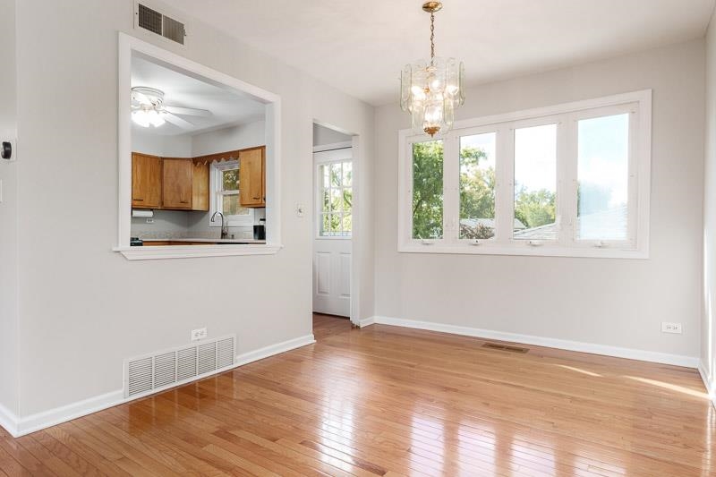 7924 Westview Lane Woodridge, IL 60517 - Photo 14 of 40 an empty room with wooden floor and windows