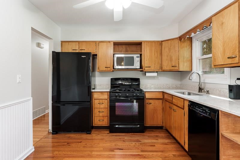 7924 Westview Lane Woodridge, IL 60517 - Photo 16 of 40 a kitchen with stainless steel appliances granite countertop a refrigerator stove top oven and sink