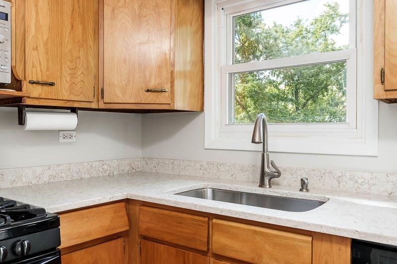 7924 Westview Lane Woodridge, IL 60517 - Photo 18 of 40 a kitchen with granite countertop a sink and a window