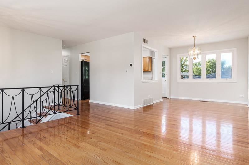 7924 Westview Lane Woodridge, IL 60517 - Photo 10 of 40 an empty room with wooden floor and windows