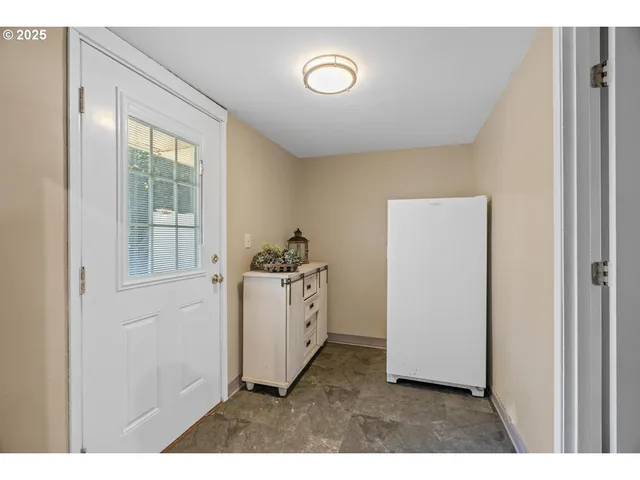 a kitchen with cabinets and window