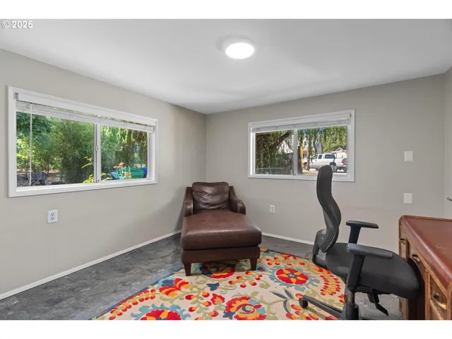 a living room with furniture rug and window