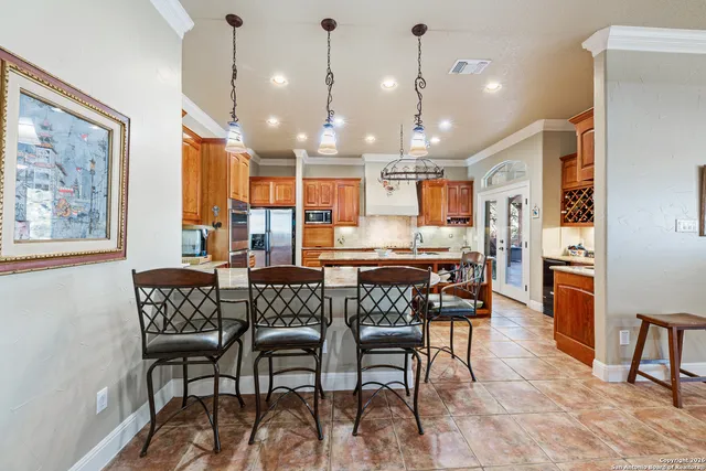a kitchen with stainless steel appliances granite countertop a sink stove and cabinets