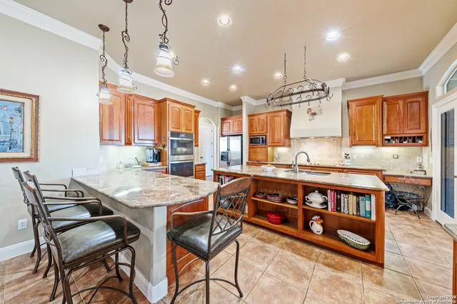 a kitchen with stainless steel appliances granite countertop a refrigerator and cabinets