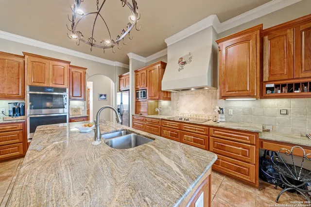a kitchen with stainless steel appliances granite countertop a sink and cabinets