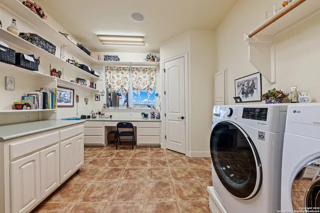 a bedroom with a bed and a flat tv screen on the dresser