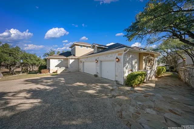 a view of a house with a yard and garage