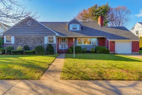a view of brick house with a yard