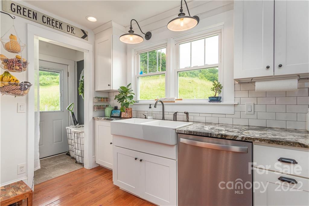 3215 Beaverdam Road Canton, NC 28716 - Photo 12 of 30 a kitchen with stainless steel appliances granite countertop a stove a sink and a granite counter tops with white cabinets