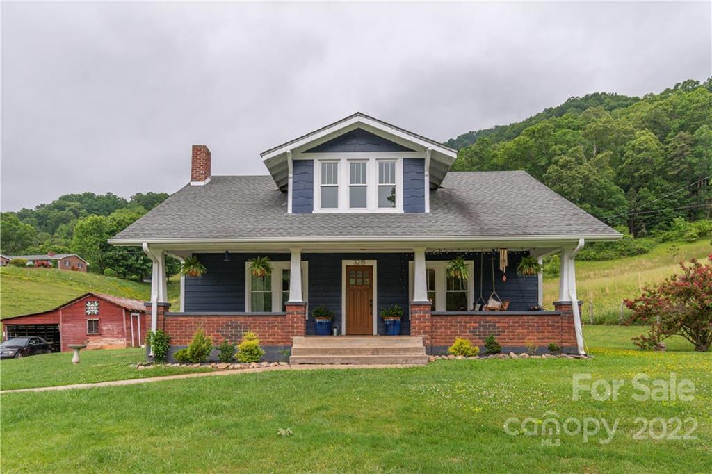 3215 Beaverdam Road Canton, NC 28716 - Photo 2 of 30 a front view of a house with a yard and green space