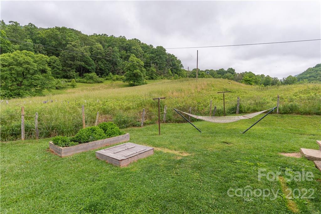 3215 Beaverdam Road Canton, NC 28716 - Photo 26 of 30 a view of a garden with a building in the background