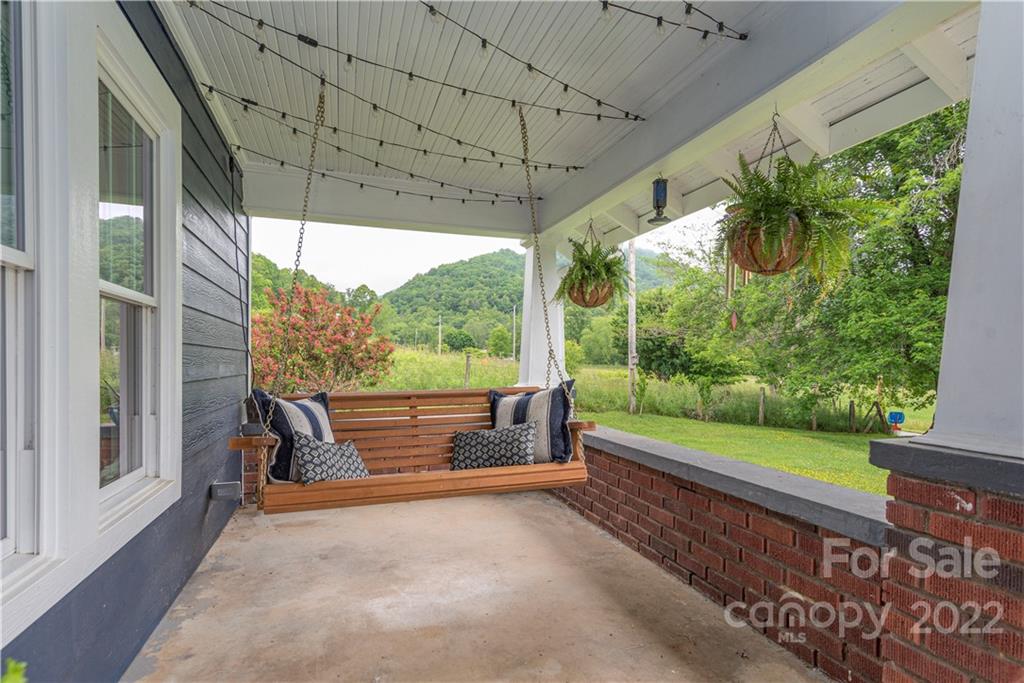 3215 Beaverdam Road Canton, NC 28716 - Photo 4 of 30 a balcony with furniture and a garden