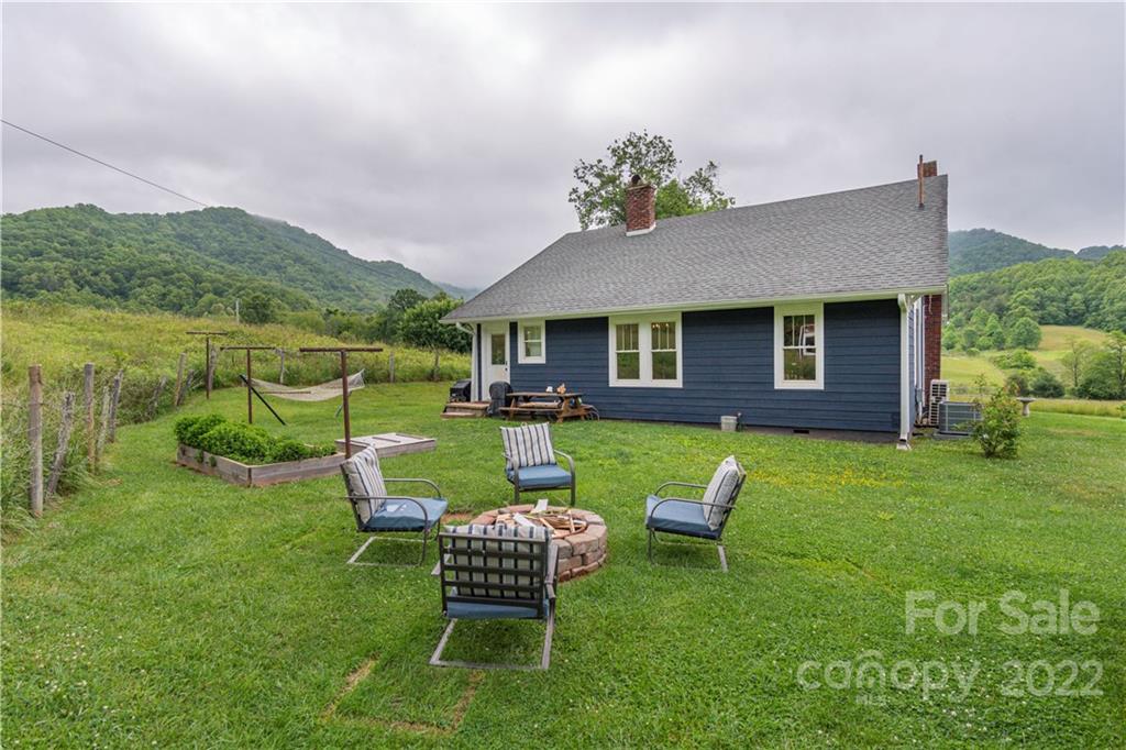 3215 Beaverdam Road Canton, NC 28716 - Photo 5 of 30 a view of a chair and table in the garden