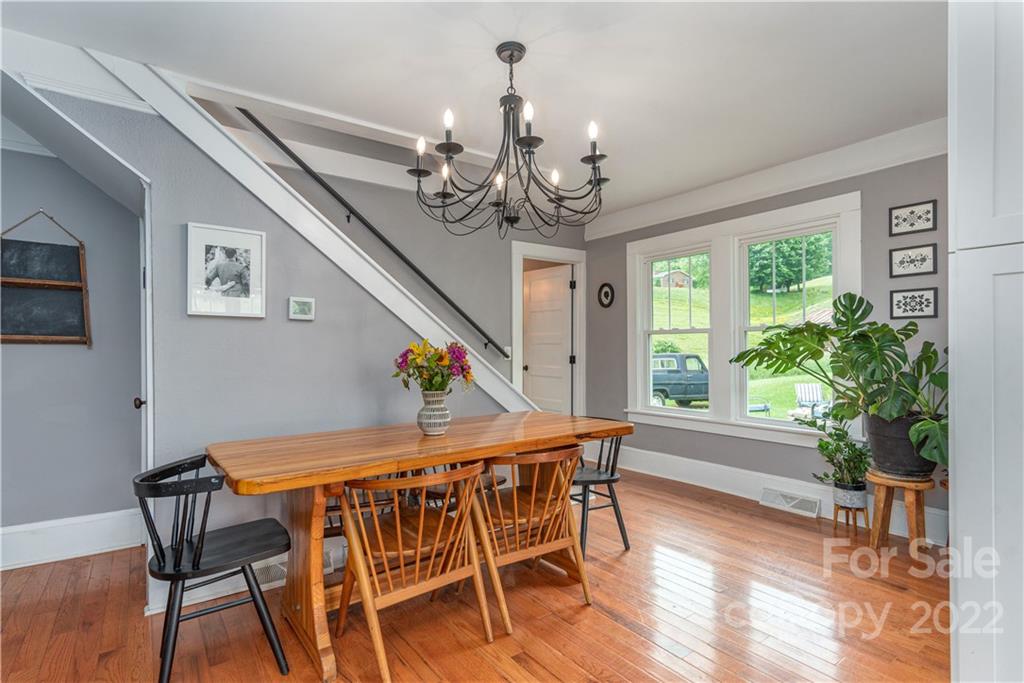 3215 Beaverdam Road Canton, NC 28716 - Photo 10 of 30 a view of a dining room with furniture window and wooden floor