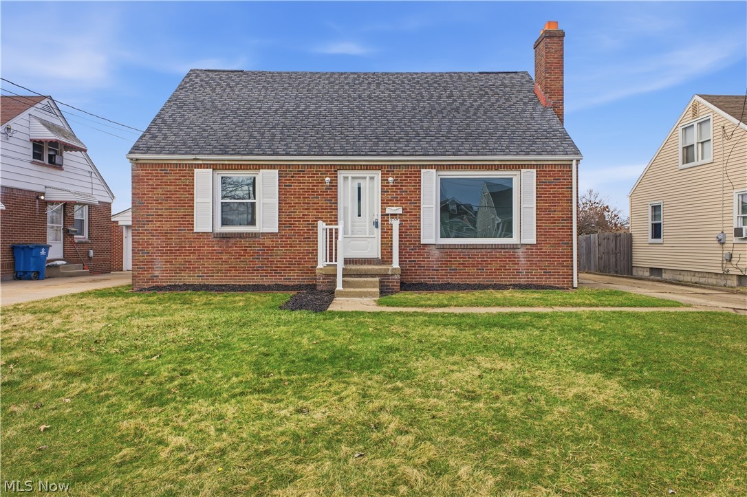 227 Wilson Street Struthers, OH 44471 - Photo 44 of 44 View of front facade with brick siding, a chimney, a shingled roof, and entry steps